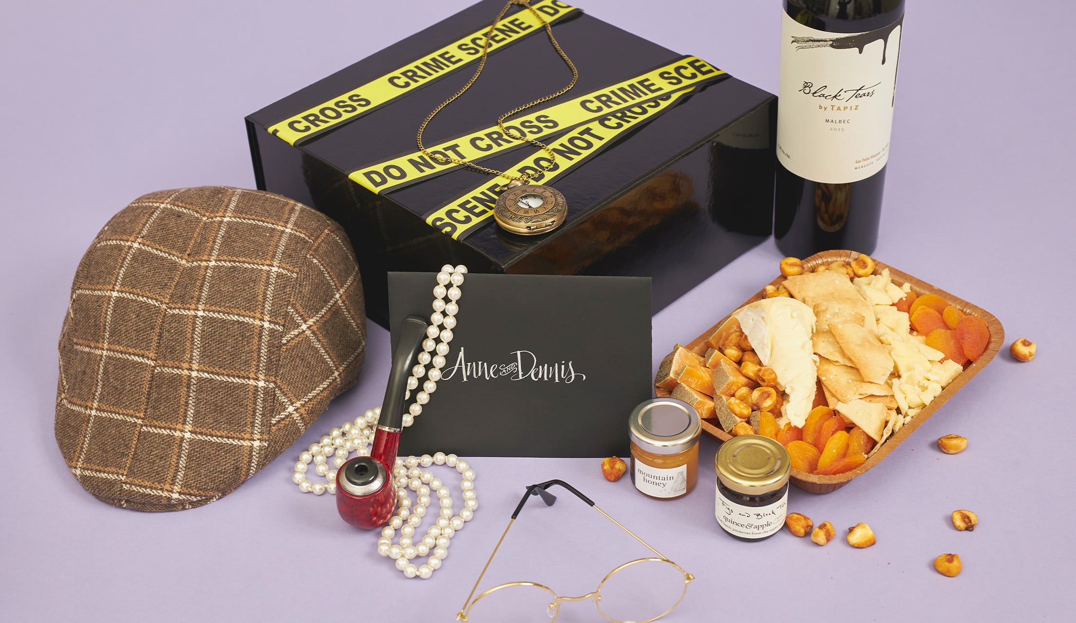 Gift box with props, food, and drinks for a virtual murder mystery theme party