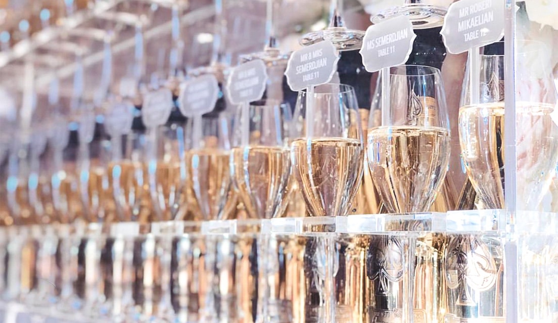 Wall of champagne glasses and toppers at a gala