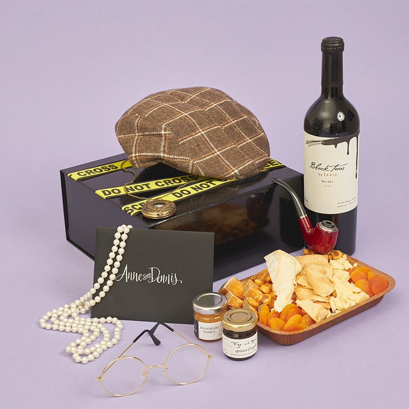 Gift box with props, food, and drinks for a virtual murder mystery theme party